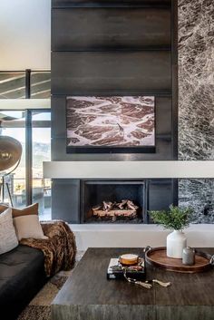 modern living room with fireplace and large painting