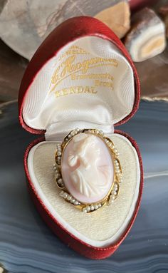 Item: Antique 10K Yellow Gold Natural Pearl Framed Cameo Brooch Pendant for Necklace. This is stamped 10K. The display box shown in the photos is not included. The chain is for demonstration purposes only and is not included. Measurements: 1 & 3/8th inches tall (including the bale). 1 inch wide. It weighs 6.49 grams. Condition: Antique, previously owned. There is no damage to note. There may be very minor signs of age/use. Please see our other listings, we combine shipping for savings. Heirloom Cameo Brooch Gift, Heirloom Cameo Brooches For Gifts, Heirloom Cameo Brooches As Gift, Heirloom Oval Brooches For Gifts, Heirloom Brooches With Cabochon For Gifts, Heirloom Oval Brooches As Gift, Heirloom Engraved Brooches For Gifts, Antique Cameo Jewelry, Historic Jewelry