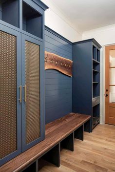 a room with blue walls and wooden flooring next to a shelf filled with books