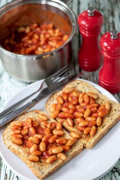 two pieces of toast with beans on them