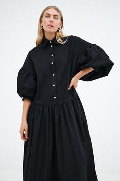 Meet our Ada Dress, the ultimate warm weather staple. She's a midi shirtdress handcrafted from 100% European poplin cotton, featuring pockets and a dropped gathered waistline that falls over your frame with ease. Her clean lines and sharp collar harmonize with dramatic dropped shoulders and full-bodied sleeves, elevating your style for any occasion.[SPLIT] Maritza, in black and in light blue, is 5'9.5" (177 cm) tall, wearing size XS. Shannon, in white, is 5'8" (173 cm) tall, wearing a size M. Mi Tunic Hoodie, Professional Dresses, Black White Red, Tunic Dress, Clean Lines, Warm Weather, Sundress, Red Dress, Final Sale