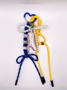 two pairs of blue and yellow lanyards attached to each other on a white surface