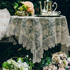 the table is covered with lace and flowers