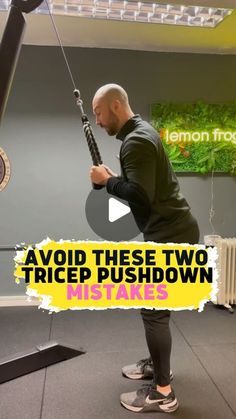 a man is doing exercises in the gym while holding a large object with one hand