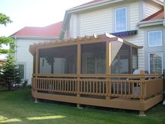 a large house with a covered porch in front of it and an awning over the deck