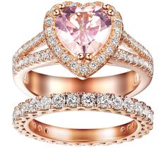 two wedding rings with an heart shaped pink diamond in the center and white diamonds on each band