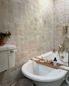 a bathroom with a bathtub, sink and toilet in the corner next to it