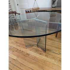 a glass table with wooden flooring in a room