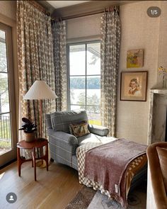 a living room filled with furniture and a fire place in front of a large window