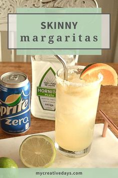 a drink sitting on top of a wooden table next to limes and a can