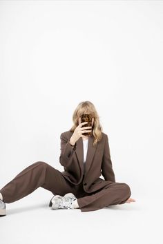 a woman is sitting on the floor and taking a selfie with her cell phone