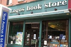 there is a bike parked in front of the book store that sells books and magazines