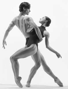 two dancers in black and white pose for the camera