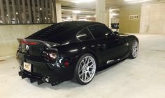 a black sports car parked in a parking garage