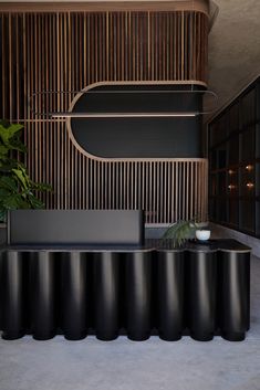 a black table and some plants in a room