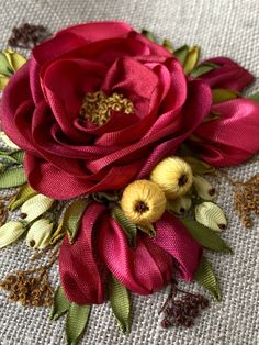 a close up of a flower on a table cloth