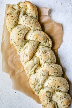 a piece of bread that has been braided with some kind of herbs on it