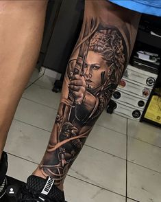 a woman with a bow and arrow tattoo on her leg