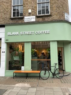 a bicycle is parked in front of a coffee shop