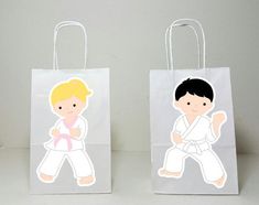 two paper bags with stickers on them, one has a boy and the other is a girl