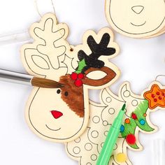 some wooden cutouts with christmas decorations on them and a marker in front of them