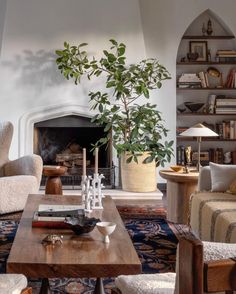 a living room filled with furniture and a fire place in the middle of a room