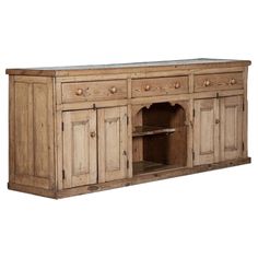 a large wooden cabinet with two doors and drawers on one side, an open shelf to the other