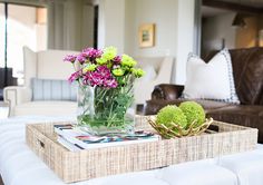 a tray with flowers on top of a couch