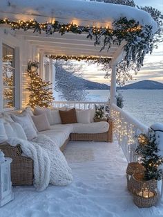 a porch covered in snow with christmas lights