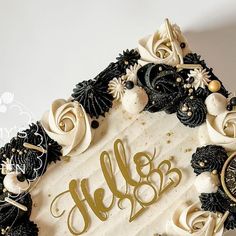 a white cake with black and gold decorations