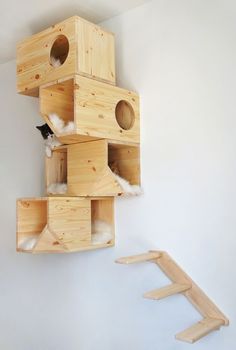 a cat house made out of wooden boxes