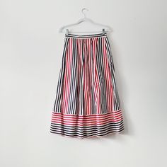 80s red, white, and blue pinstriped pleated midi skirt from brand Breckenridge. One side has a pocket and the other is hook and eye closure. Vertical stripes meet horizontal stripes at the hem.  Lightweight fabric of 70% cotton, 30% linen.  Vintage size 8 - fits like medium 13 inches across the waist,  31.5 inches full length Check out other listings in our shop for more vintage clothing, housewares, and more: Uprightvintagemi.etsy.com *Please read the item description and title, view all photos Striped Pleated Skirt For Work, Pleated Striped Skirt For Work, Summer Workwear Skirt With Vertical Stripes, Striped Relaxed Midi Skirt, Spring Striped Tiered Skirt, Spring Striped Skirted Bottoms, Relaxed Striped Midi Skirt, Spring Relaxed Skirt With Striped Hem, Striped Skirt For Spring Daywear