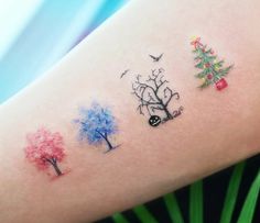 tattoos on the arm of a woman with trees and birds