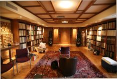 a room filled with lots of books and furniture