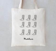 a tote bag with the words maddelant written in black ink on it