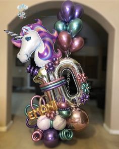 a unicorn balloon sculpture with the number 10 surrounded by balloons