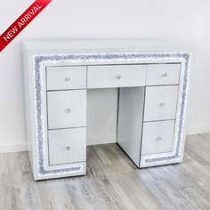 an image of a white desk with silver trimmings on the top and bottom