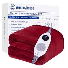 a red blanket with an electric heating device on top of it and packaging in the background