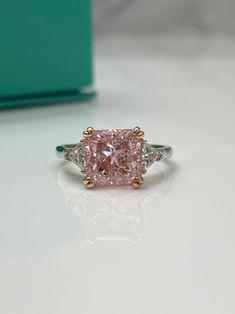 Final sale! May not be returned. Materials: Sterling silver 925 Rhodium plating Rose gold plating Finest CZ diamonds Crushed ice pink CZ diamond Center Stone size: 10mm*10mm The ring is absolutely gorgeous. Can be engagement, promise or just a beautiful ring for someone who loves jewellery. Size 6 left. Will be making more sizes upon request! Luxury Pink Sterling Silver Rings, Luxury Pink Sterling Silver Diamond Ring, Luxury Pink Diamond Ring In Sterling Silver, Pink Diamond Rings With Diamond Cut, Dazzling Pink Emerald Cut Ring, Elegant Gia Certified Pink Diamond Ring, Elegant Pink Gia Certified Diamond Ring, Pink Sterling Silver Diamond Ring With Vs Clarity, Pink Luxury Rings With Center Stone