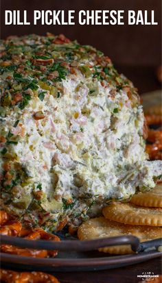 a cheese ball with crackers on the side and text overlay that reads dill pickle cheese ball