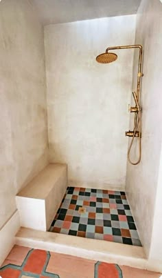 a bathroom with a tiled floor and shower