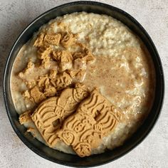 a bowl filled with oatmeal, peanut butter and crackers on top