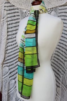 "Enjoy some classy 70's style with this long striped scarf/sash showcasing the classic 70's colors of spring green, yellow, aqua, ecru, gold and black encased by a black border. Scarf is sure to be a fun, versatile accessory adorning many an outfit! Being in good vintage condition, it does show some minor wear  - including a few spots toward middle of scarf but is not very noticeable unless you're looking for it. Please see all pictures as this is part of description. Length: approx. 57\" Width: 12\" Weight: .7 oz." Striped Scarf, Long Neck, 70s Retro, Spring Green, Style Chic, 70s Fashion, Black Border, Head Scarf, Green Yellow