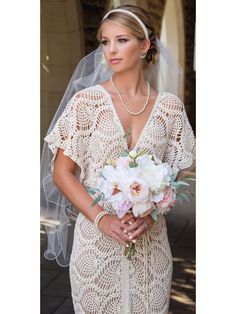 a woman in a wedding dress holding a bouquet