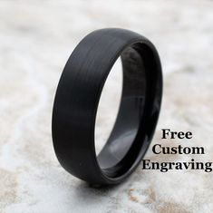 a black ring sitting on top of a stone floor