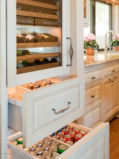 an open cabinet in a kitchen filled with food