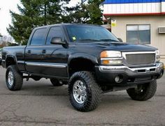 a black truck parked in front of a building