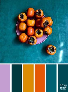 some oranges are on a purple plate and there is color swatches in the background