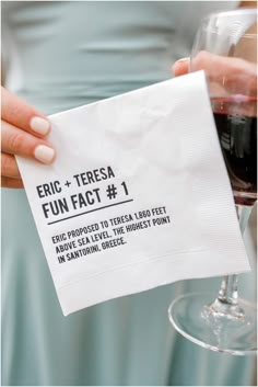 a person holding a napkin with the words eric + teresa fun fact 1 printed on it