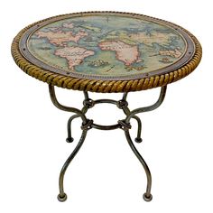 a table with a world map on it's top and metal legs, against a white background